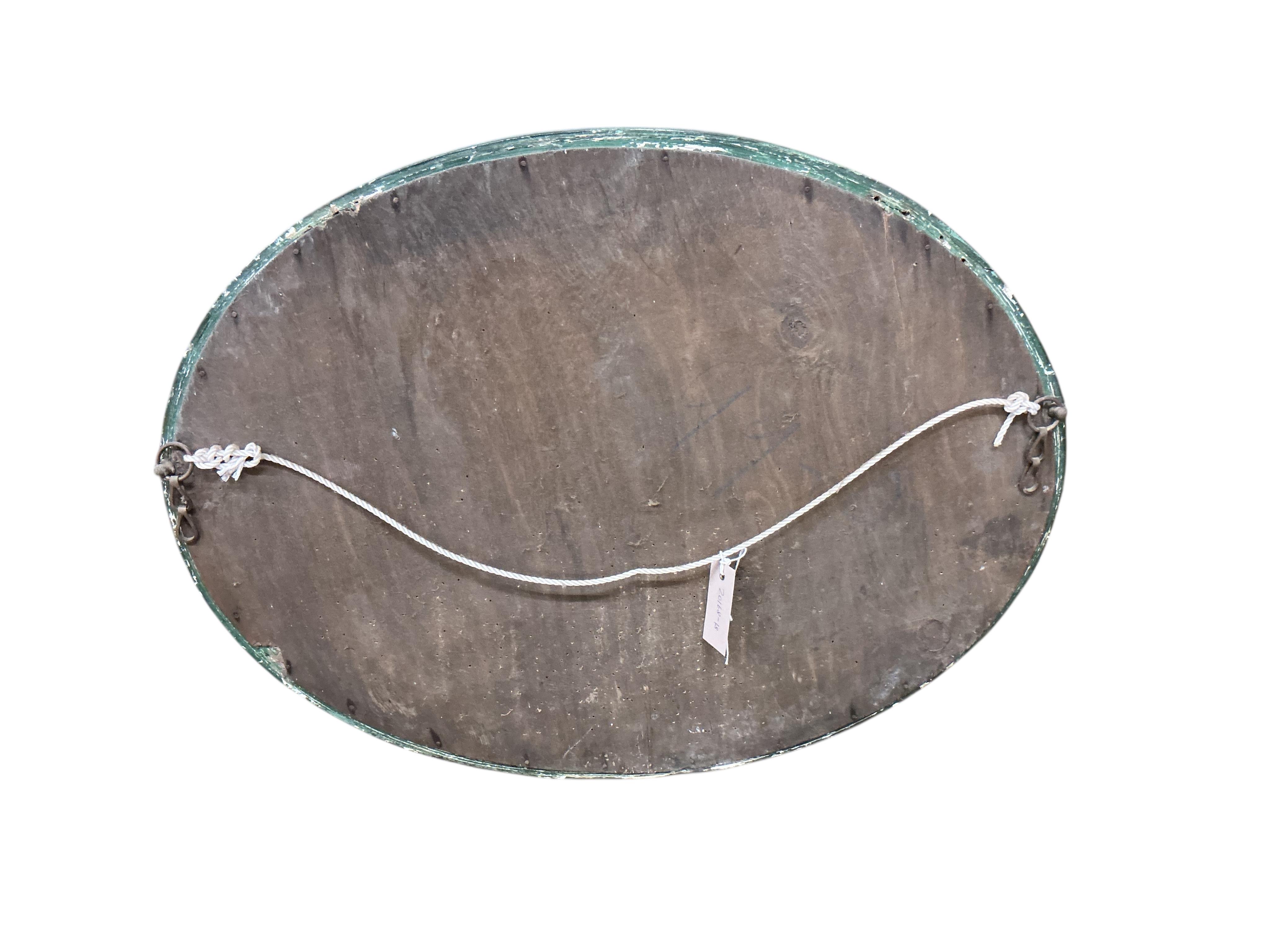 An early 20th century oval chinoiserie lacquer wall mirror, width 68cm, height 53cm